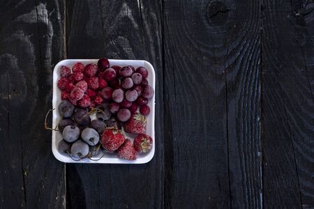 Healthy sweet dessert on dark rustic wooden background. Frozen fruits. Copy spaceの写真素材