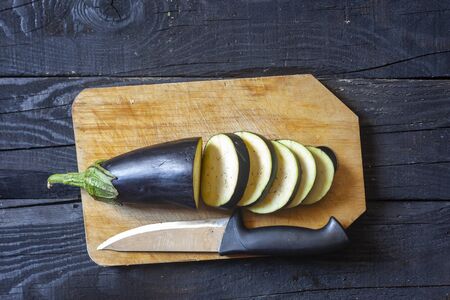 A big sliced eggplant on cutting board. Fresh raw organic foodの写真素材