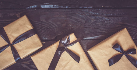 Halloween gift box with black ribbon on dark wooden table. Holiday, Birthday, Celebration concept....