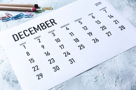 Simple 2019 December monthly calendar on table with office suppliesの写真素材