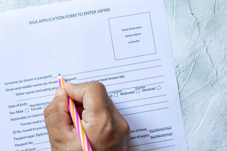 Person filling Visa application form to enter Japan.の写真素材