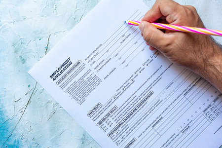 Hand filling Standard Application for Employment. HR, Hiring, Applicant Filling job application. HR,...