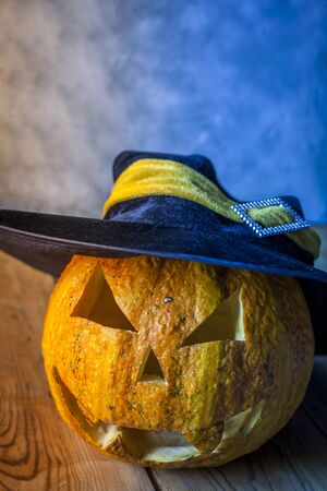 Halloween Pumpkin jack lantern with witch hat on wood. Copy spaceの写真素材