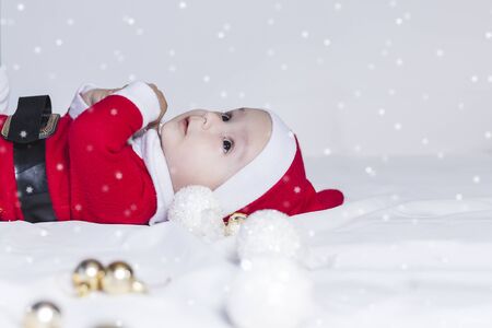 Merry christmas from Little Santa. 6-9 months old baby boy worn in costume of Santa Claus. Copy space, Free space or Free space for text and ads.の写真素材