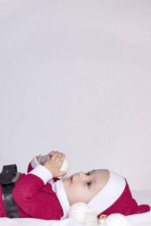 Merry christmas from Little Santa. 6-9 months old baby boy worn in costume of Santa Claus. Copy space, Free space or Free space for text and ads.の写真素材