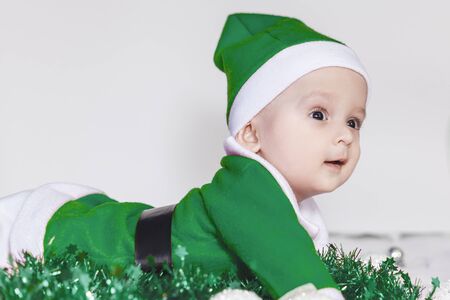 Merry christmas from Little Santa. 6-9 months old baby boy worn in costume of Santa Claus. Copy space, Free space or Free space for text and ads.の写真素材