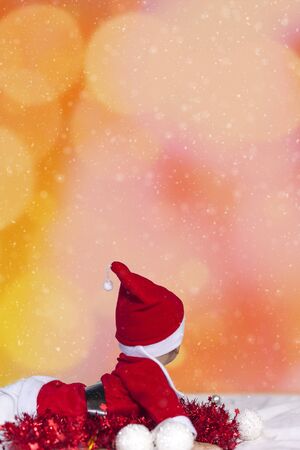 Merry christmas from Little Santa. 6-9 months old baby boy worn in costume of Santa Claus. Copy space, Free space or Free space for text and ads.の写真素材