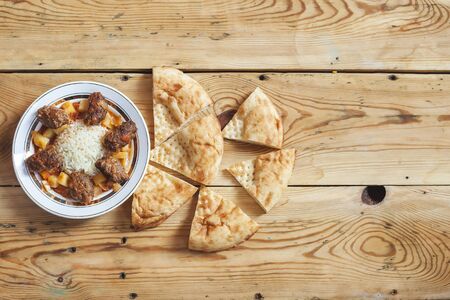 Homemade food on the table. Cutlets, boiled rice, potatoes and slices of bread on wooden tableの写真素材