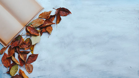 Autumn conceptual background. A cup of hot tea with fall leaves and empty space