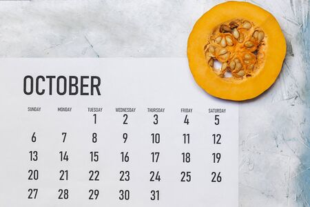 Fall concept. October 2019 Paper Calendar with round slices of pumpkinの写真素材