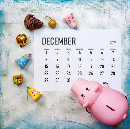 December 2019 calendar with christmas toys and piggy bank. Planning Shopping for Christmas holidays....