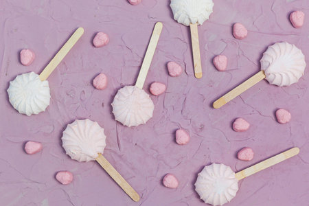 Marshmallows on pink background. Colorful marshmallow sweets with copy space. View from above or top...