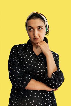 Portrait of young middle-eastern woman. Turkish, Arabian or West Asian housewife in black dress.