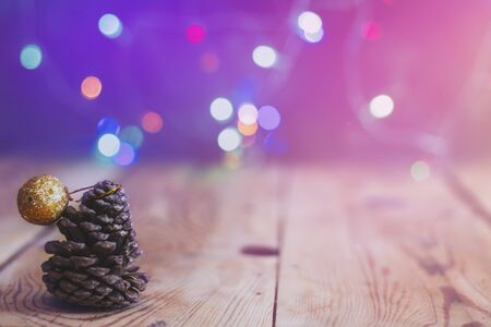 Christmas decor with bright bokeh lights. Magic Winter at Christmas Time. Xmas decoration with Christmas toys and balls on vintage wooden desk. Advent Christmas Decorations. Copy space for text and adの写真素材