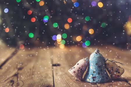 Christmas decor with bright bokeh lights. Magic Winter at Christmas Time. Xmas decoration with Christmas toys and balls on vintage wooden desk. Advent Christmas Decorations. Copy space for text and adの写真素材