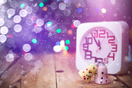 Christmas holiday eve. New year decor with bokeh lights. Magic Winter. Clock at midnight. Greeting...