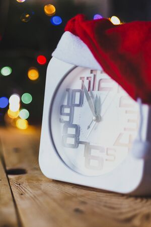 Christmas holiday eve. New year decor with bokeh lights. Magic Winter. Clock at midnight. Greeting new 2020 Year. Clock with blurry magic lights. Copy space for text and adの写真素材