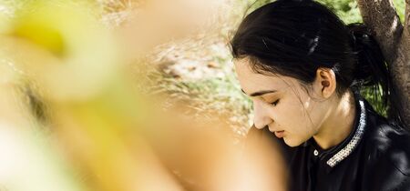 Portrait of beautiful middle-eastern woman at apple garden. Young female posing in autumn park in sunny day. Portrait of woman at natureの写真素材