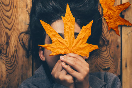 Autumn woman. Fall season concept. A portrait of lying on wooden floor woman. Young, beautiful and...