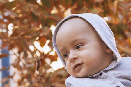 Young Muslim woman in hijab holding her 1-year-old baby boy, hugging and kissing. Happy Muslim mother in abaya clothing kiss and play with her little child. Cute family, middle-eastern mother and sonの写真素材