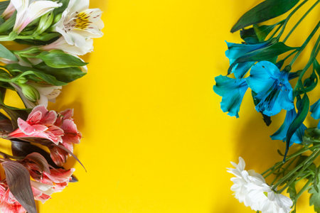 Colorful Springtime Flowers On Yellow Background. Easter or Spring background. Vibrant spring...