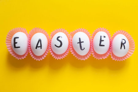 Bright Easter image with white eggs on the yellow background. White eggs with text - Easter on the...