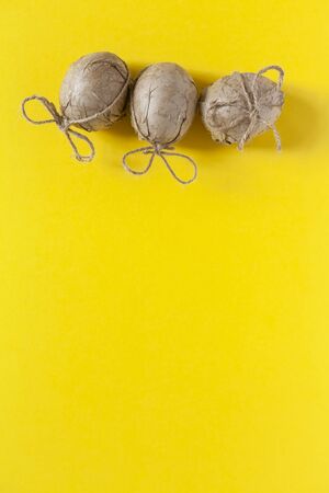 Easter eggs decorated with crafty paper and ribbon on the dark backgroundの写真素材