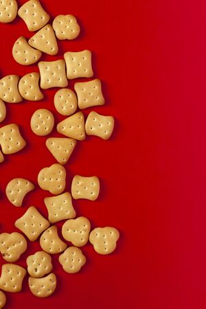 View from above to sweet mini cookies on the red backgroundの写真素材