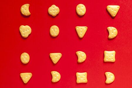 View from above to sweet mini cookies on the red backgroundの写真素材