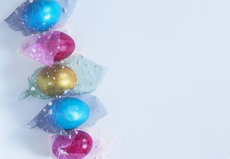 Decorated easter eggs on the white paper backgroundの写真素材
