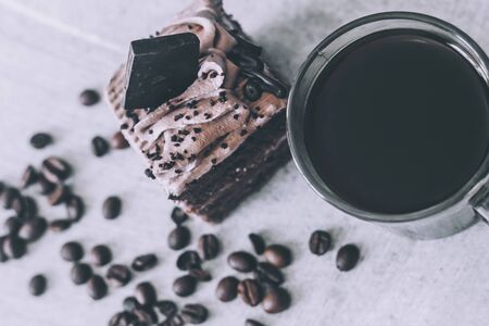 Hot coffee drink and sweet cake chocolate tart dessert pastry on mable backgroundの写真素材