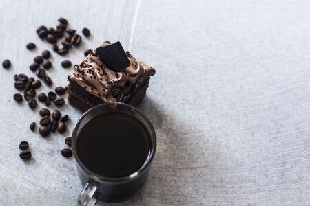 Hot coffee drink and sweet cake chocolate tart dessert pastry on mable backgroundの写真素材