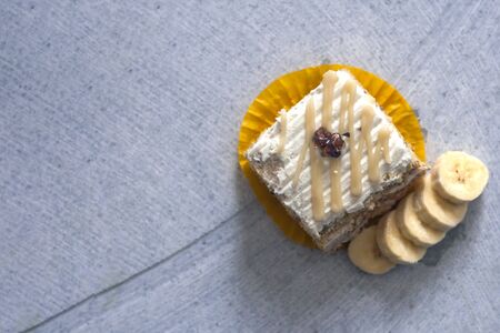 Pastry cream cake with banana and walnut on marble background.の写真素材