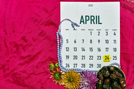 April monthly calendar on the red silk textile background. Islamic Ramadan Eid festive background...