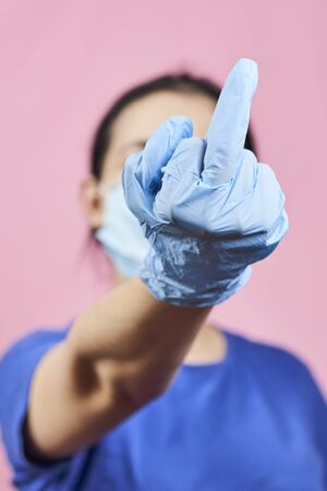 Woman showing middle finger handgesture.の写真素材
