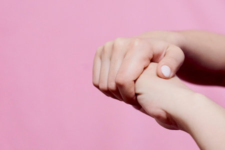 An unrecognizable woman arms. Woman showing hands with beautiful light manicure on nails. Stylish...