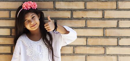 Portrait of a beautiful teen girl at outdoors. A little girl having fun during summer vacations. Face expression, Feeling happy, Fun, Playful and Joyful teen. Happy childhoodの写真素材