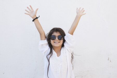 Portrait of a beautiful teen girl at outdoors. A little girl having fun during summer vacations. Face expression, Feeling happy, Fun, Playful and Joyful teen. Happy childhoodの写真素材