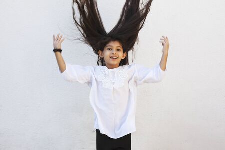 Portrait of a beautiful teen girl at outdoors. A little girl having fun during summer vacations. Face expression, Feeling happy, Fun, Playful and Joyful teen. Happy childhoodの写真素材