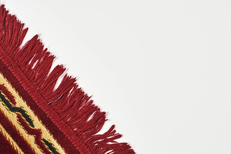 Cropped view of Islamic praying carpet on the white backgroundの写真素材