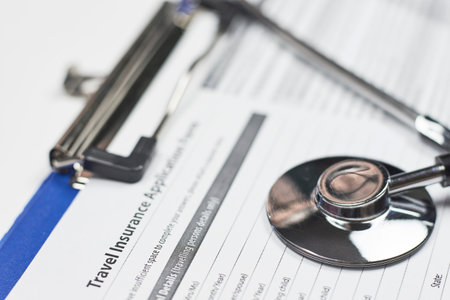 Travel insurance application form and stethoscope. Safe travel and holiday conceptの写真素材