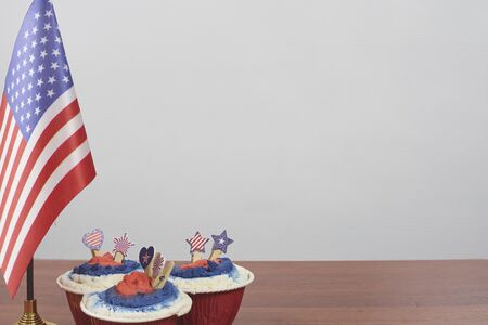 Celebrating Fourth of July. Happy Independence day. Sweets decorated in traditional colors and American national flagの写真素材