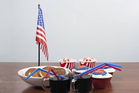 Celebrating Fourth of July. Happy Independence day. Sweets decorated in traditional colors and American national flagの写真素材