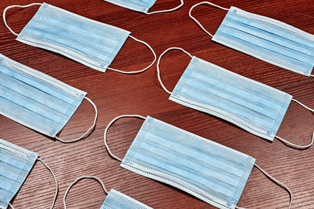 Background of surgical face masks on the wooden table