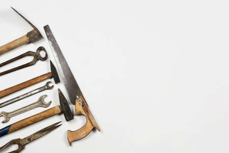 Old and rustic handy working tools on the white background with copy space on the rightの写真素材