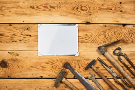 Labor day background with different working tools placed around the whiteboard