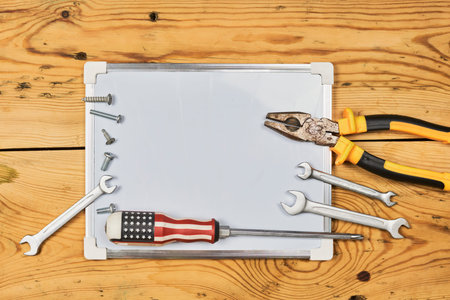 Labor day background with different working tools placed around the whiteboard