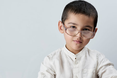 Portrait of 7 years old mixed race boy looking at the camera. A smart schoolboy portrait against the...