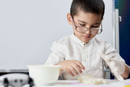 Schoolboy conducting scientific experiments at the workshopの写真素材