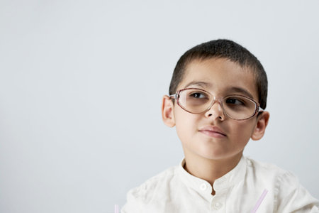 Smart boy in glasses against the white background